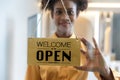 A business sign that word Ã¢â¬ËOpenÃ¢â¬â¢ on cafe or restaurant hang on door at entrance. Royalty Free Stock Photo